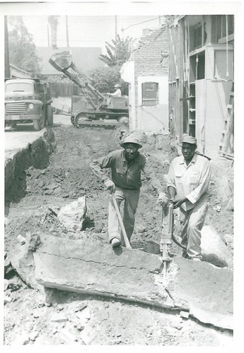 Original Caption: "Holton's boys breaking up footing, City jail construction"