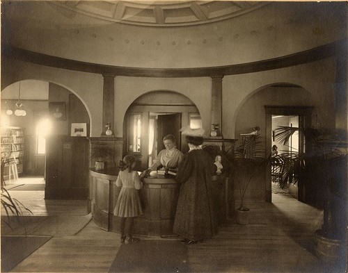 Nellie Keith at Reference Desk with Patrons