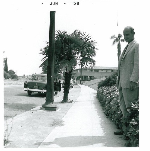 C. H. Lane on Edge of Sidewalk at Wide Street