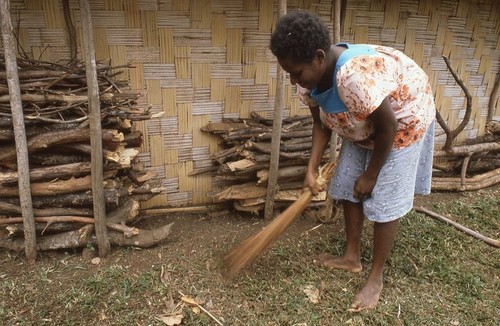 Krisser sweeping near her house in Labo