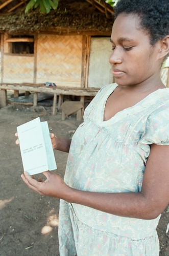 Woman holding Vanuatu Electoral and Identity Card