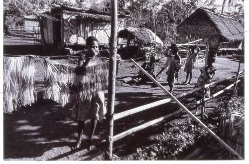 Preparing grass skirt for Independence Anniversary ritual dances