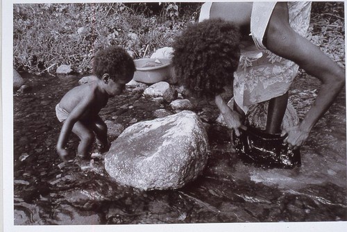 Young child learns women's work