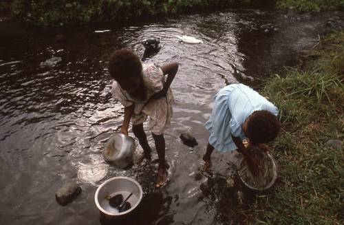 Young girls finish up dish washing