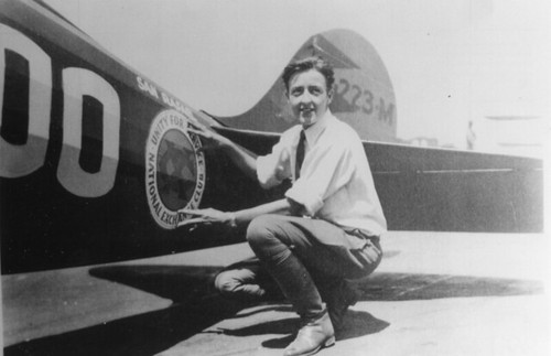 Bobbi Trout placing decal on Golden Eagle at the start of first Powder Puff Derby 1929