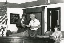 Greg Lyon holding an object at Sister City commemoration, circa 1989