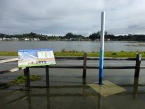 Multiuse Pathway sign and pole showing effects of sea level rise, 2017