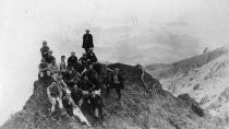 Hikers from the California Alpine Hiking Club, resting at the top of a hill, 1923