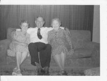 Two women and one man sitting on sofa in George's home in Towanda, 1954