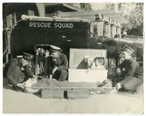 Mill Valley firemen of the Rescue Squad with a fire victim, circa 1919