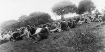 Large group of hikers from the California Alpine Hiking Club, sitting on a grassy slope, 1923