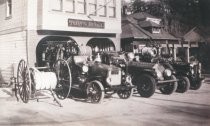 Fire trucks outside of fire station, early 1900s