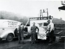 Dino Esposti, Al Gastoni, and Duke Enos beside a bathroom wall, date unknown