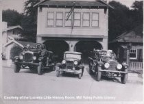 Fire trucks outside of fire station, circa 1920s