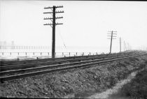 Railroad commuter train line, telephone poles, Richardson Bay, circa 1930's