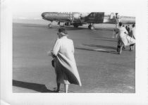 Passengers walking outside to board United Airlines propeller plane, 09/11/1954