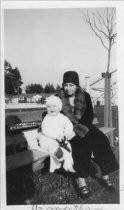 Woman and 11 month old baby sitting outside, 1931