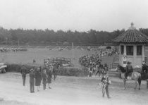 Horse show or horse race in outdoor arena, unknown