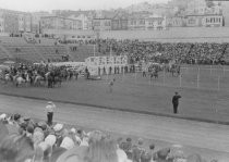 Horse show or horse race in outdoor arena, unknown