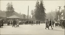 Crowd outside of the Mill Valley railway depot and people walking across Miller Avenue, circa 1920