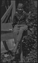 Miriam Coyne in hiking pants, seated, 1919