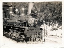 Woman standing beside Mt. Tam & Muir Woods Railway locomotive, circa 1925