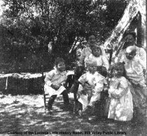 Women and children camping, date unknown