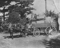 Edward Ezekiel driving Emporium wagon, date unknown