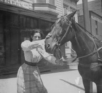 Kate Robinson with a horse, 1900