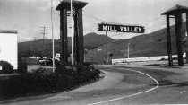 Black and white photograph of Mill Valley entrance sign, circa 1940