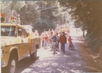 Families walking behing fire engines at the 1974 4th of July Parade