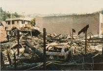 Dowd's ruins with burned-out cars, 1984