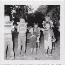 Children eating watermelon at a picnic, 1956