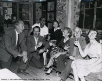 Several people enjoying drinks, circa 1950s