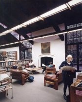 People reading in chairs by fireplace, 1994