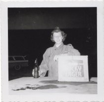 Woman posing with a Lucky Lager beer box label, 1956