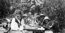 Group at picnic table, date unknown