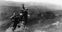 Four hikers from the California Alpine Hiking Club on a rock, 1923