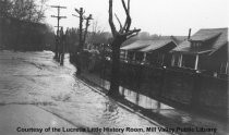 Pedestrians on flooded street and sidewalk, 1925