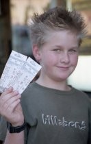 Boy holding tickets, 1999