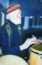 Roger Somers playing bongo drums, 1998