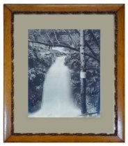 Cascade Falls, with three unidentified subjects (two men and a woman) standing next to it