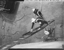 Women on ladder with hose training during World War II, c. 1940's