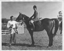 George is pictured with an unidentified rider and horse at the Southern Marin Horseman Association Arena, 1970