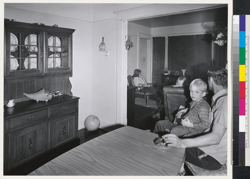 [A family at home.]