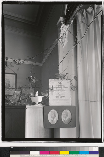 [Home interior with diploma and graduation photographs, Oakland, California.]