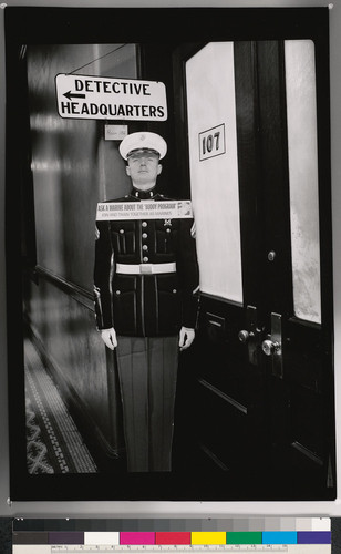 [Hallway with a cardboard cutout of a Marine, public interior in California.]