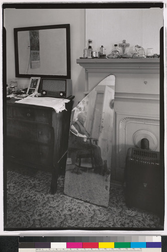 [Home interior with mirror reflecting the image of an elderly man, Oakland, California.]