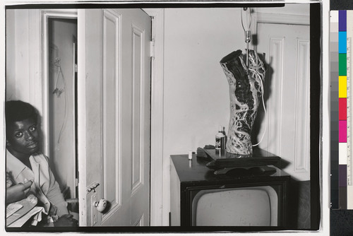 [Home interior with an African American young man and a television set in Oakland, California.]