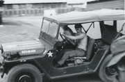 Photograph by Gustafsson of A Fellow Soldier Standing Driving A Jeep Around Camp